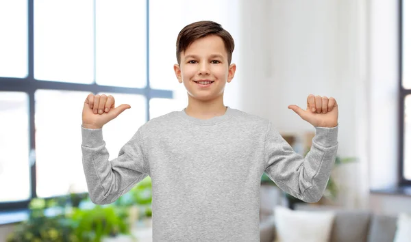 Szczęśliwy uśmiechnięty chłopiec wskazujący palcem na siebie — Zdjęcie stockowe