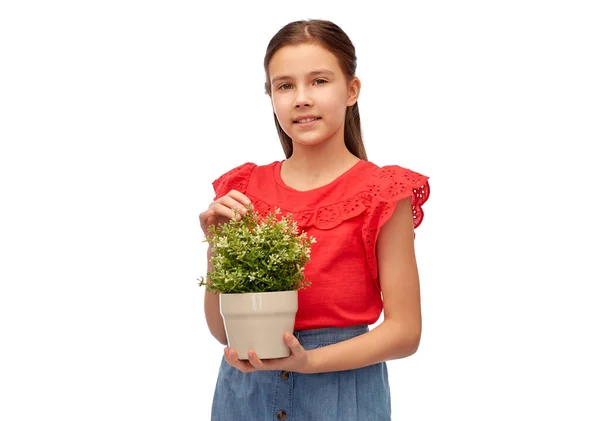 Gelukkig lachend meisje holding bloem in pot — Stockfoto