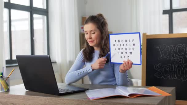 Teacher with alphabet having online class at home — Stock Video