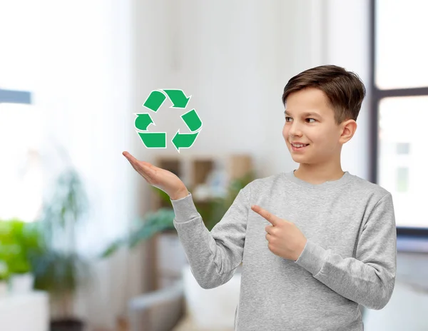 Menino sorrindo mostrando sinal de reciclagem verde — Fotografia de Stock