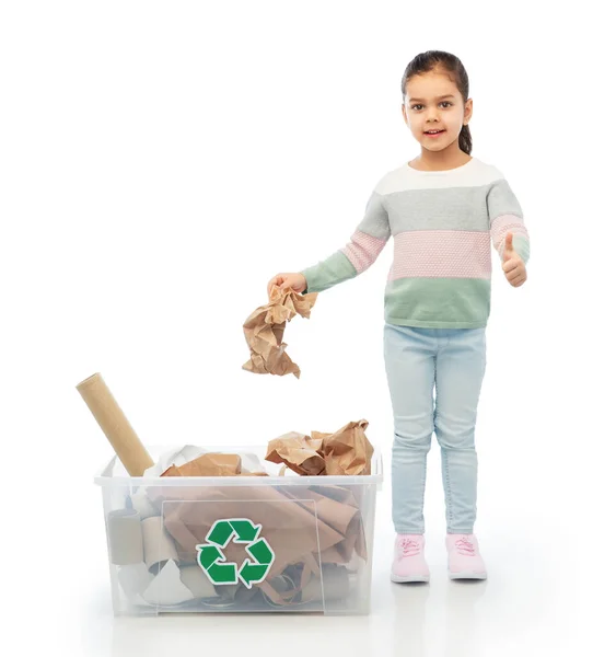 Girl sorting paper waste and showing thumbs up — Stock Photo, Image