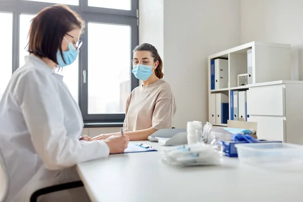 Médecin avec presse-papiers et patient à l'hôpital — Photo