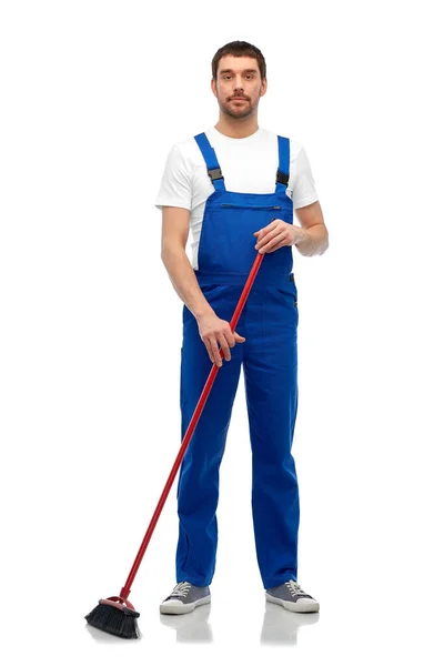 Limpador masculino no piso de limpeza geral com vassoura — Fotografia de Stock