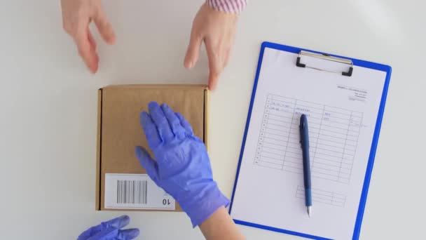 Customer hands giving parcel box to mail worker — Stock Video