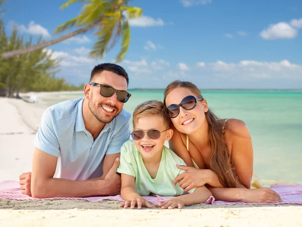 Familia feliz acostado sobre fondo de playa tropical —  Fotos de Stock