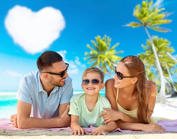 Família feliz deitado sobre fundo de praia tropical — Fotografia de Stock