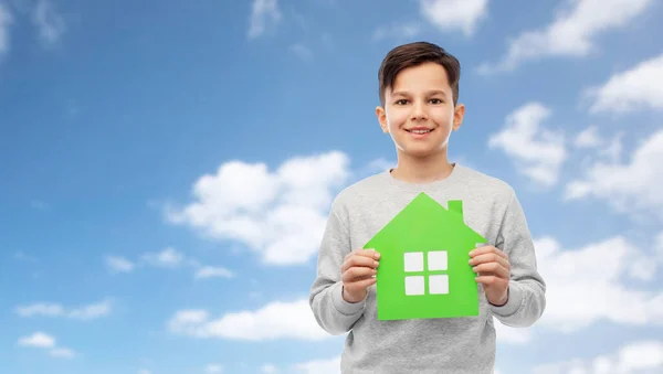 Smiling boy holding green house icon — Stock Photo, Image