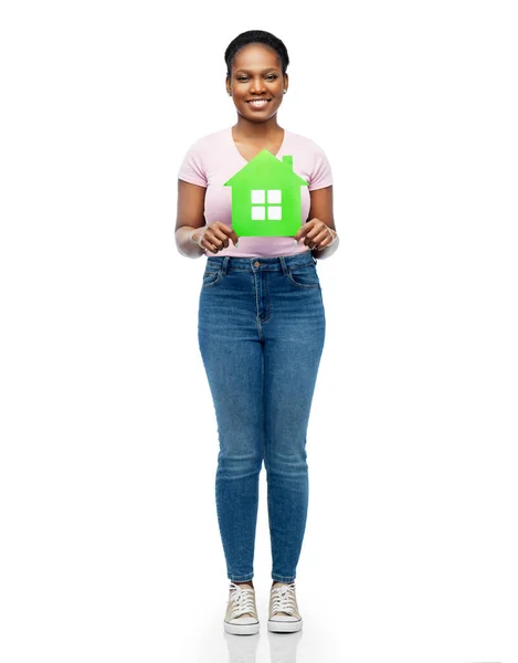 Smiling african american woman holding green house — Stock Photo, Image