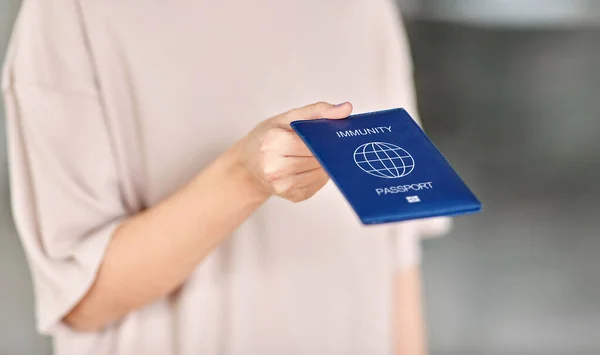 Close up of woman holding immunity passport — Stock Photo, Image