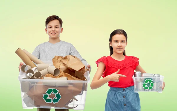 Smiling girl and boy sorting paper and metal waste — Stock Photo, Image