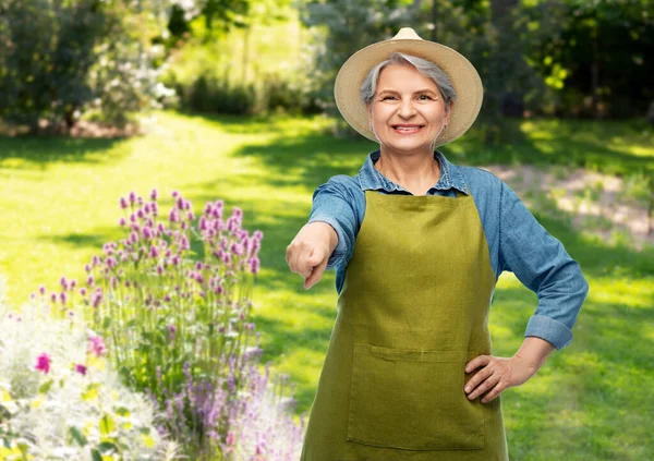 穿着花园围裙微笑的老年妇女画像 图库照片