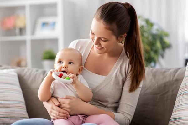 Mother and little baby with teething toy at home — Stock Photo, Image