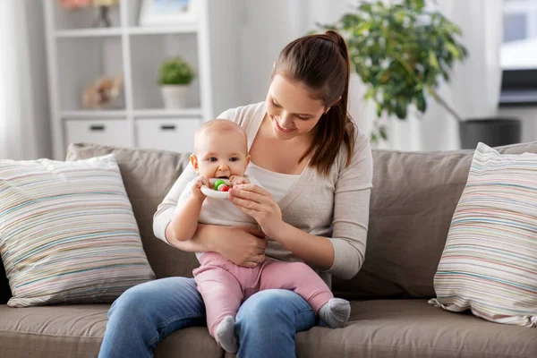 Mother and little baby with teething toy at home — Stock Photo, Image