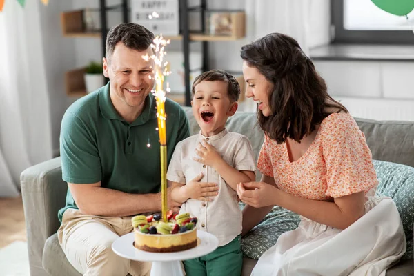 Happy family with birthday cake at home — Stock Photo, Image