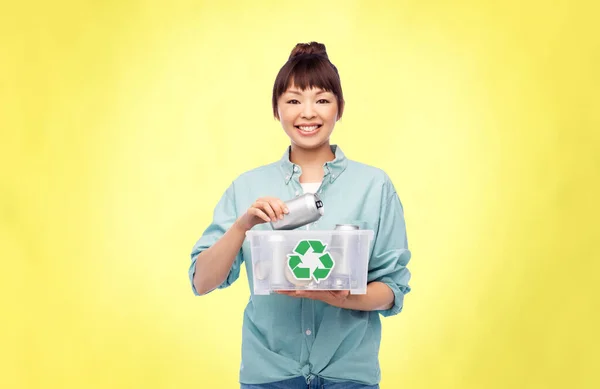 Smiling young asian woman sorting metallic waste — Stock Photo, Image