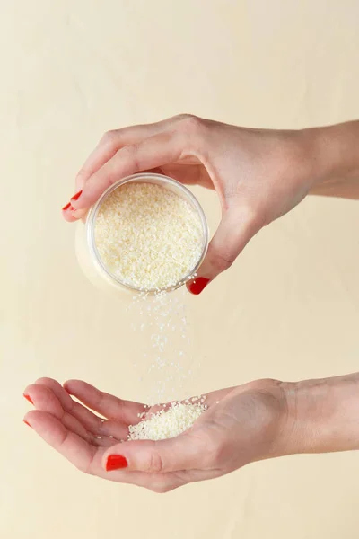 Hands with bath salt in jar — Stock Photo, Image