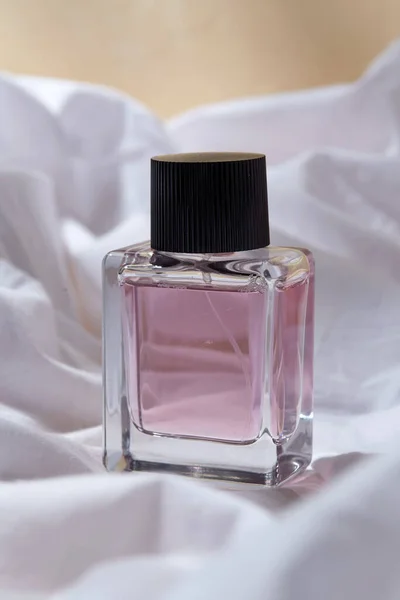 Bottle of perfume on white sheet — Stock Photo, Image