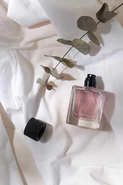 Bottle of perfume and on white sheet — Stock Photo, Image