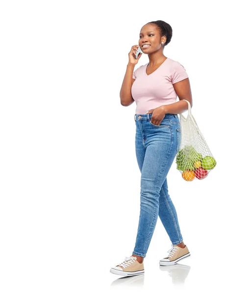 Mulher com comida em saco líquido chamando no smartphone — Fotografia de Stock