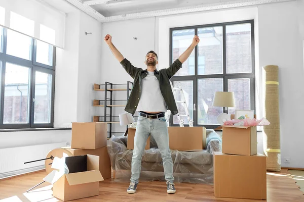 happy man with boxes moving to new home