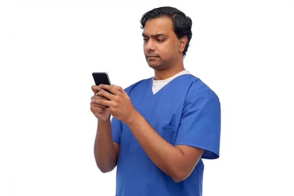 Indian läkare eller manlig sjuksköterska med hjälp av smartphone — Stockfoto