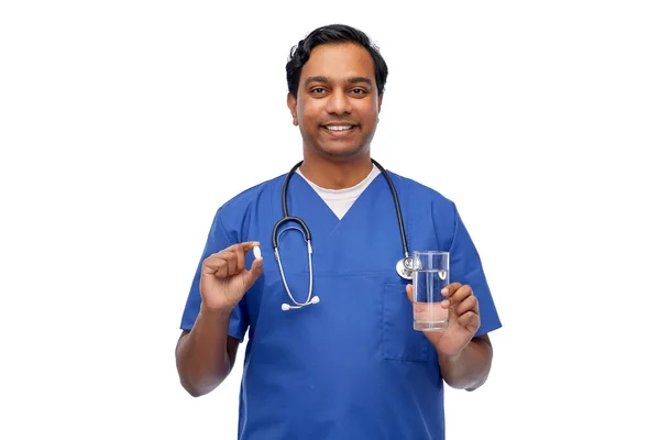 Médico indiano com remédio e copo de água — Fotografia de Stock