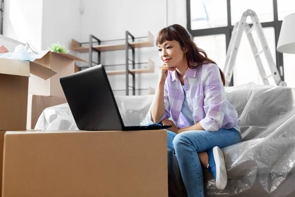 Mujer con portátil que se muda a un nuevo hogar —  Fotos de Stock