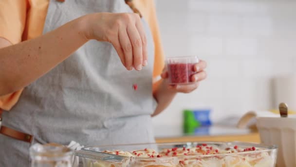 Woman decorating roll buns with dried raspberries — Stock Video