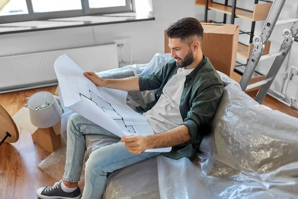 Hombre feliz con el plan de mudanza a un nuevo hogar —  Fotos de Stock