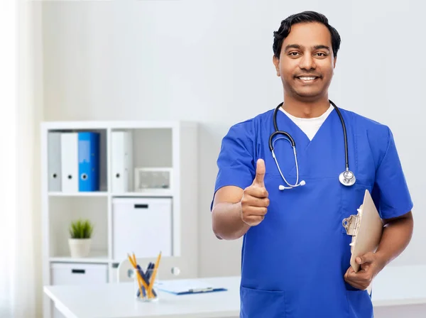 Smiling doctor or male nurse showing thumbs up — Stock Photo, Image