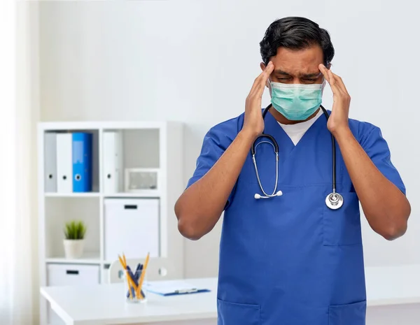 Maskeli stresli Hintli doktorun başı ağrıyor. — Stok fotoğraf