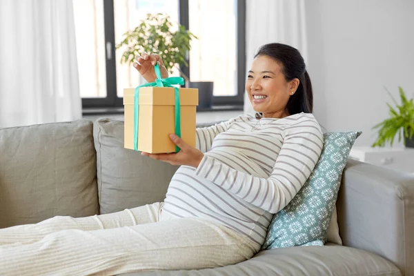 Glückliche Schwangere mit Geschenkbox zu Hause — Stockfoto