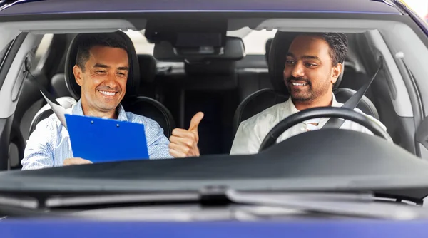 smiling car driving school instructor and driver