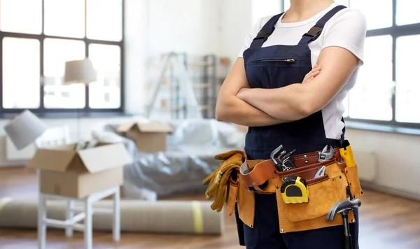 Close up of female worker in overall at new home — Stock Photo, Image