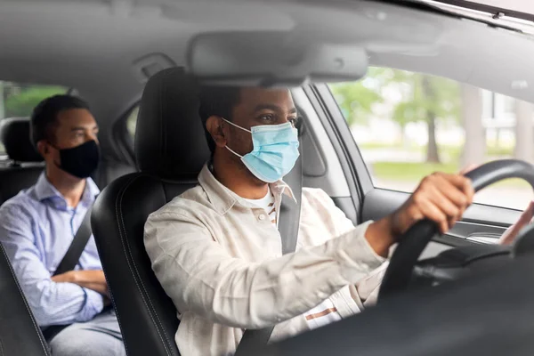 Motorista masculino em carro de condução máscara com passageiro — Fotografia de Stock