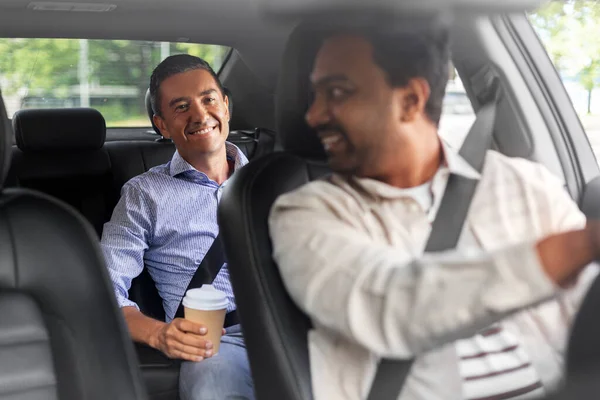 Male passenger with coffee talking to car driver — Stock Fotó