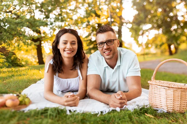 Pareja feliz en manta de picnic en el parque de verano —  Fotos de Stock