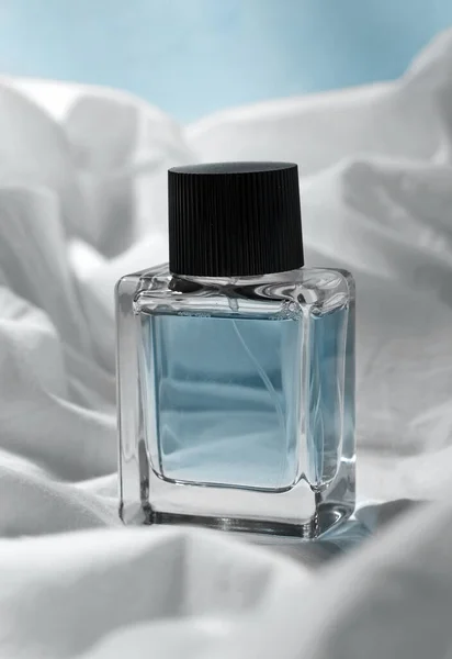 Bottle of perfume on white sheet — Stock Photo, Image