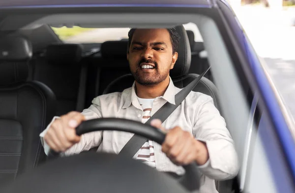 Angry indian man or driver driving car — Stock Photo, Image