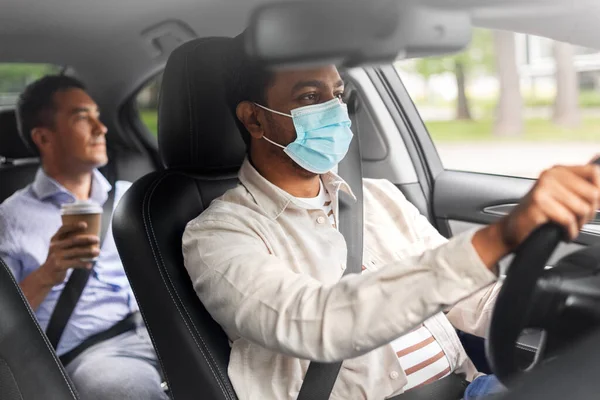 Male passenger with coffee and car driver in mask — Stock Photo, Image