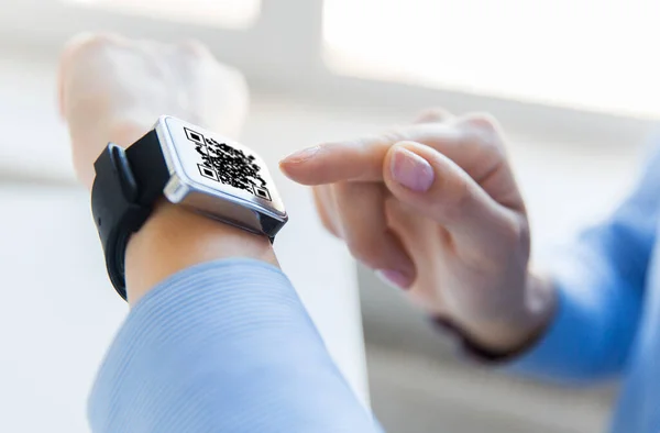 Womans hands with qr code on smart watch — Stock Photo, Image