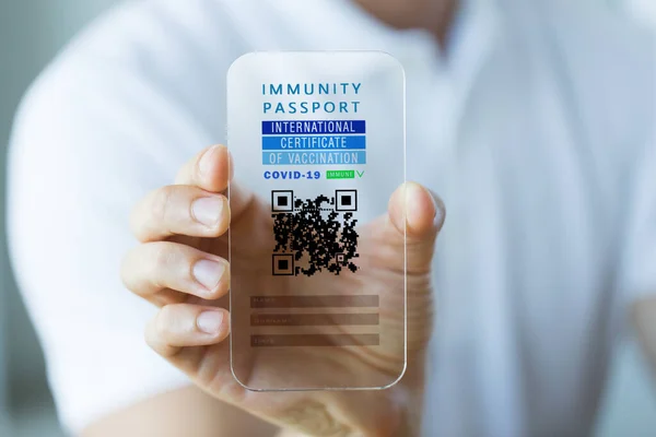 Hand with virtual immunity passport on smartphone — Stock Photo, Image