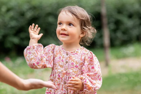 幸せな笑顔の赤ちゃんの女の子は大人に手を与える — ストック写真