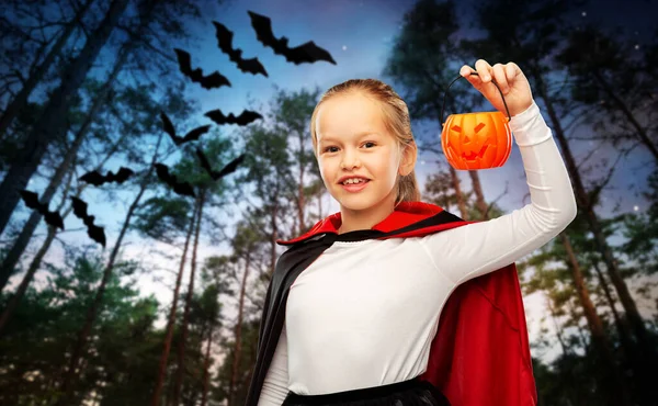 Girl in halloween costume of dracula with pumpkin — Stock Photo, Image