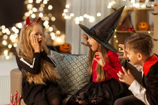 Ungar i halloween kostymer leker hemma — Stockfoto