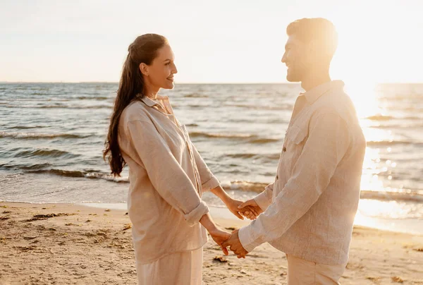 Casal feliz de mãos dadas na praia de verão — Fotografia de Stock