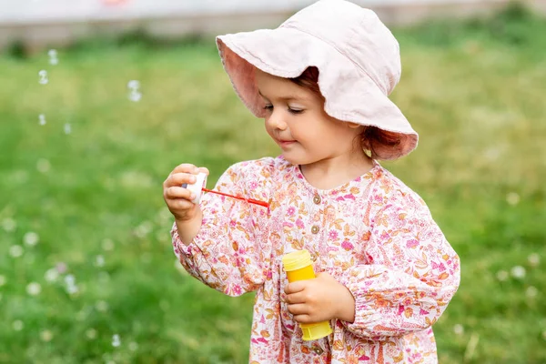 Niña feliz soplando burbujas de jabón en verano — Foto de Stock