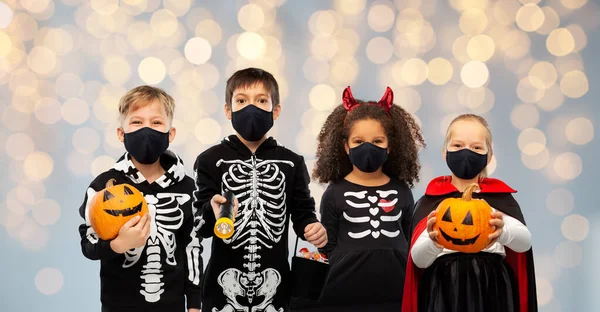 Children in halloween costumes and reusable masks — Stock Photo, Image