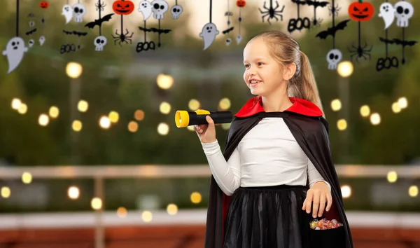 Girl in halloween costume of dracula with candies — Stock Photo, Image