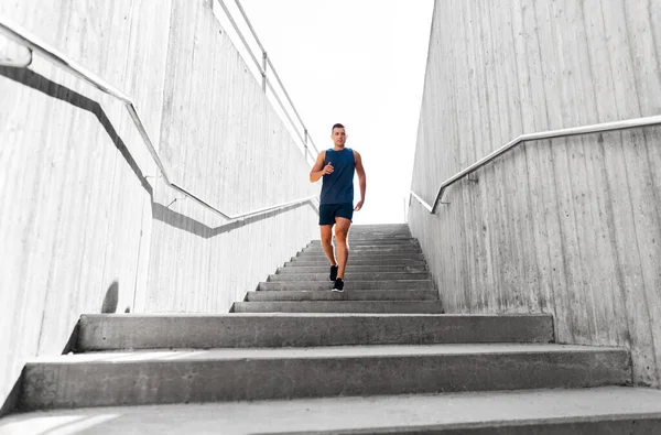 Young man running downstairs — Stock Photo, Image